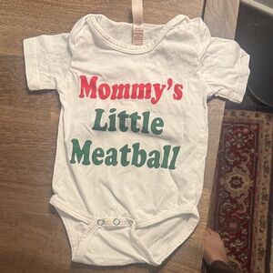 White Baby Onesie with Red and Green Text